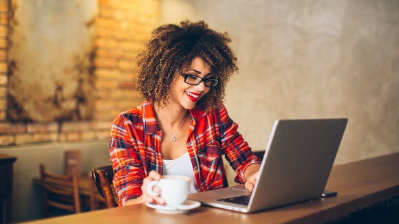 woman-smiling-looking-at-salary-report-on-computer woman-smiling-looking-at-salary-report-on-computer